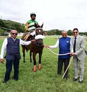 Pure For Sure (Antony Raj S up) winner of the MYSORE SUMMER MILLION 2025, being led in by trainer Vinesh V Naik on Wednesday races at Mysore.